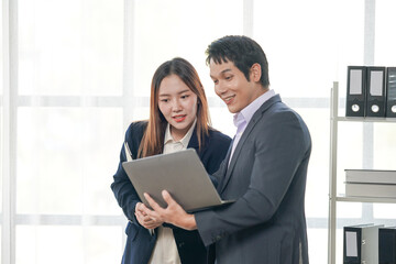 Business Professionals Collaborating on Laptop