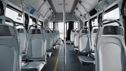 Futuristic video of empty modern city bus interior with symmetrical rows of gray seats and sleek design

