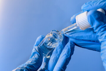 Preparing a solution using a dropper and vial in a laboratory setting with a focus on precision and...