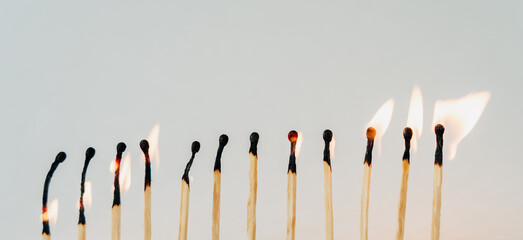 Conceptual image series using matches — new, burned, and burning — to represent stages of...