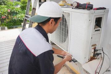 Technician Repairing Outdoor Air Conditioning Unit with Wrench, Close-Up of HVAC Maintenance and Repair Work, Professional Air Conditioner Installation or Service in Progress