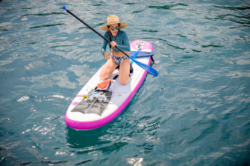 Woman tourist paddle board at the sea summer, vacation long weekend traveling in island
