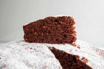 Slice of delicious caprese cake resting on top of the rest of the cake