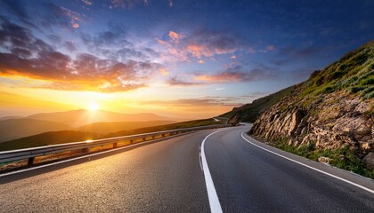 curving asphalt highway road along a rocky hill with beautiful sunset sky background