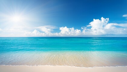 Fototapeta premium a summer vacation holiday background of a tropical beach and blue sea and white clouds with sun flare