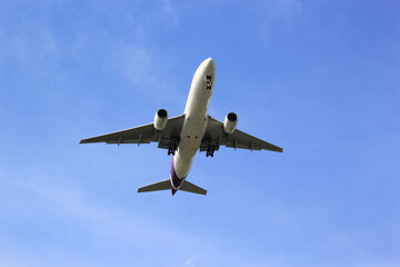 Airplane is flying above the clouds on beautiful sky background,Travel and transportation concept.