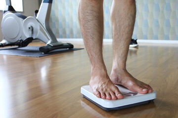 Male on the weight scale for check weight.Diet.Health and weight loss concept