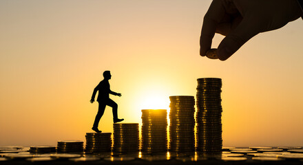 Investment growth and financial success concept with man climbing money steps silhouette at sunset