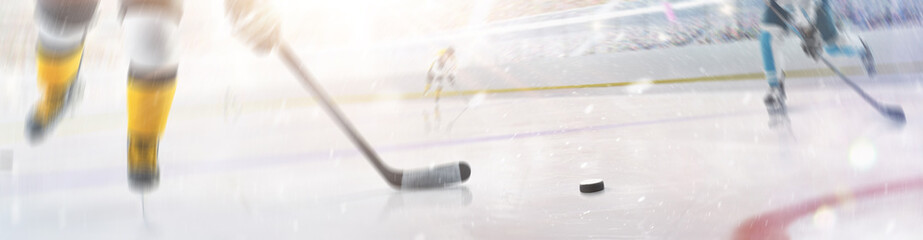 Hockey concept. Focus on the puck. Close-up. Professional hockey player in motion. Sport action