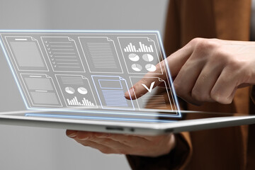 Woman approving documents on virtual screen above tablet computer indoors, closeup