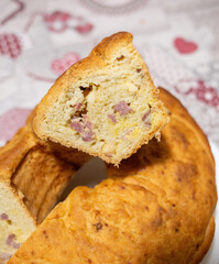 Neapolitan tortano, a slice of savory cake showing salami and cheese filling