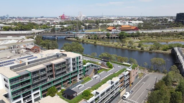 Aerial drone above Kensington and Footscray, showing Vline and Metro trains in Melbourne