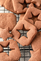 Shortbread chocolate cookies with curred star form on baking tray, close up