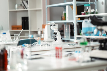 Modern scientific laboratory interior with advanced equipment and microscope setup for medical research, chemical testing, and biotechnology innovation in a professional healthcare environment