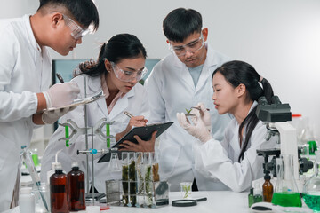 Scientists examining plant and algae samples in a modern laboratory, conducting pharmaceutical...