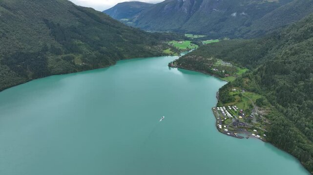 Drone shot of Lovatnet lake with blue, clear water, in the lap of the mountains