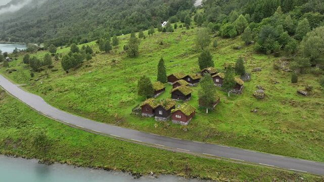 Drone shot of the traditional household cabins facing the blue lake