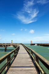 Wooden boardwalk to the beacons at the harbor entrance of Fecamp, Normandy France