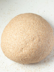 Raw bread dough on white kitchen table. Top view.