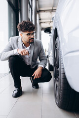 Business man choosing a car in car salon