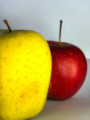 Colorful apples arranged artistically on a neutral background, showcasing vibrant red and yellow...