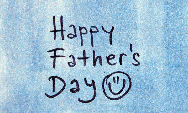Handwritten Happy Father's Day with Smiley Face on Blue

