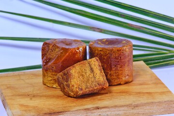 A wooden tray featuring a display of coconut sugar, a natural and healthier alternative to refined...