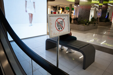 Prohibited shopping carts sign inside a modern shopping mall interior