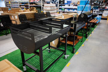 Outdoor barbecue grills on display in a hardware store showroom