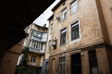 Fototapeta premium Old building facade with rustic windows and urban decay details