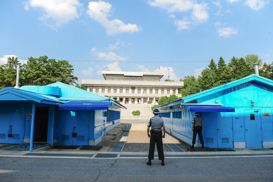 Korean Army guarding the Panmungak building in North Korea seen from South Korea across the Military Demarcation Line at Panmunjeom in the JSA.