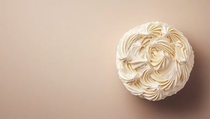 Creamy, ornate cake on a light beige surface