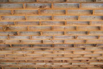 Wooden grid ceiling frame revealing intricate architectural pattern, highlighting skilled carpentry and elegant structural design with raw timber elements
