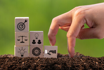 The fingers showing a step up on a wooden box with business icon, represents growth in business.