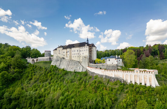 Aerial panoramic view of Cesky Sternberk Castle (Cesky Sternberk, Bohemian Sternberg) surrounded by forested hills and the Sazava river during summer in Czech Republic