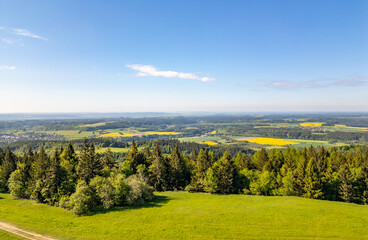 Naklejka premium Aerial view of blooming summer landscape near Jizera Mountains with green hills, forests, meadows and picturesque villages, including views toward Jested mountain in Czech Republic