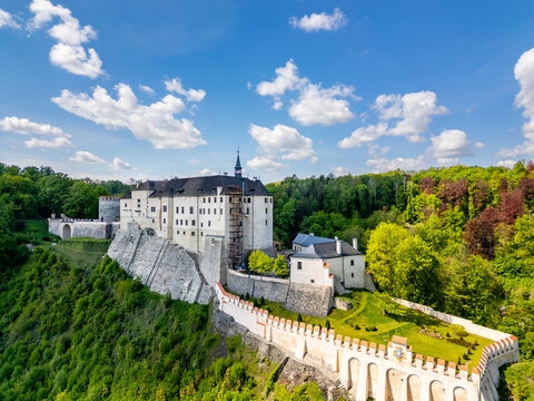 Aerial panoramic view of Cesky Sternberk Castle (Cesky Sternberk, Bohemian Sternberg) surrounded by forested hills and the Sazava river during summer in Czech Republic - Powered by Adobe