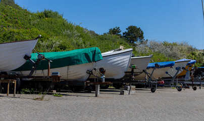 Row of Small Boats on Trailers in Summer Harbor Lot