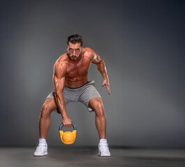 Muscular Man Exercise with Kettlebell 