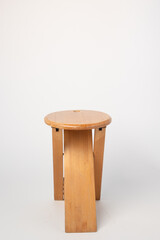 Small, folding, used wooden stool that can also serve as a side table,.