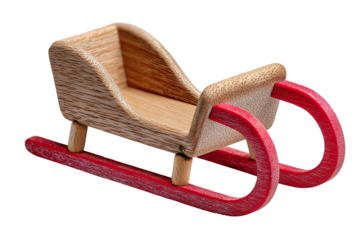 Wooden toy sled with red runners on white isolated background.