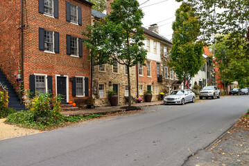 An ancient American city in Virginia with traditional architecture. Ancient brick houses, stone pavements.