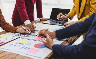 Businessman analyzing financial data with chart and graph. Business team collaborates in office,...