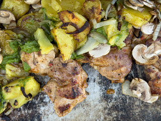Delicious grilled chicken breast served with roasted potatoes, mushrooms, and a vibrant green sauce.