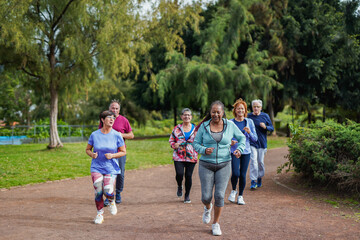 Group of active senior people doing running sport workout at city park - Healthy elderly lifestyle...