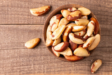 Brazil nuts in a wooden bowl. Healthy fats concept. 