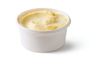 Creamy, pale yellow butter in a white plastic container.