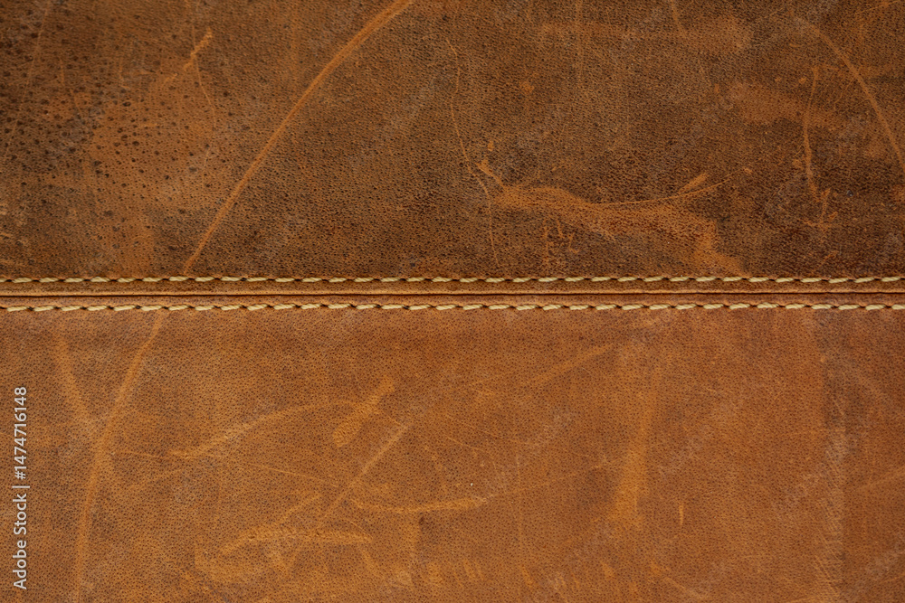 Poster high-resolution image of brown leather with a visible seam. ideal for backgrounds, textures, and des
