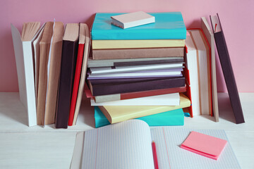 Different colorful books on white rustic tables. Back to school concept. Copy space