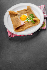 Galette sarrasin fried egg in crepe Breton galette galette complete fresh delicious gourmet food background on the table rustic food top view copy space